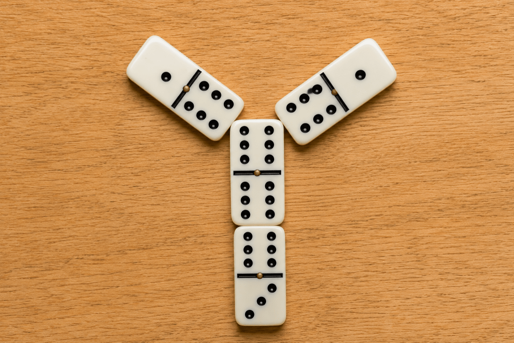 A double domino with three tiles branching off it, forming the three-pronged chicken foot shape